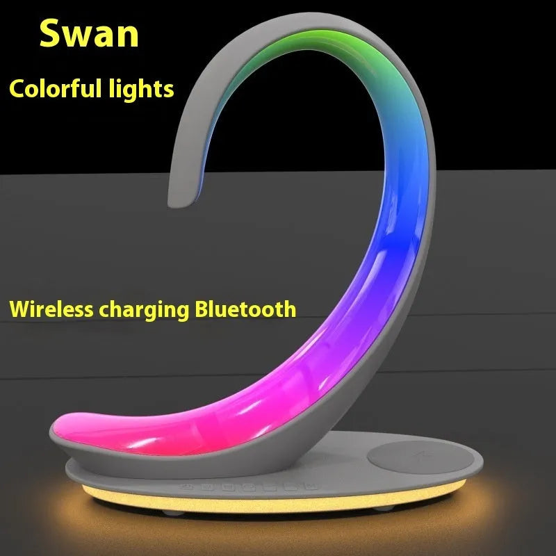 White swan-shaped desktop wireless charger with Bluetooth speaker and colourful LED atmosphere lighting