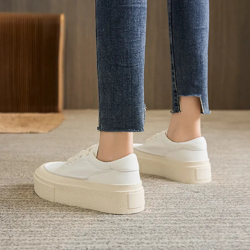 Women's black platform sports board shoes made from embossed cowhide leather with a rubber sole.