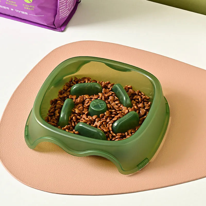 Blue plastic slow feeder dog bowl with anti-choking design on a white background
