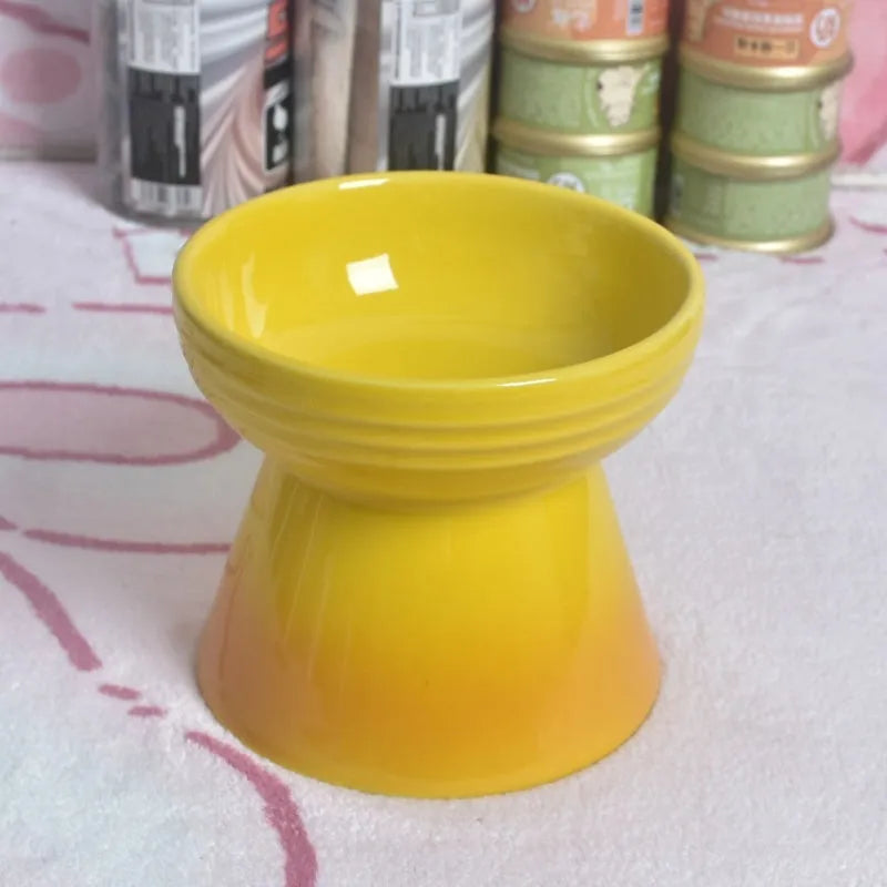 Black chin-high foot ceramic pet bowl for dogs and cats on a flat surface.