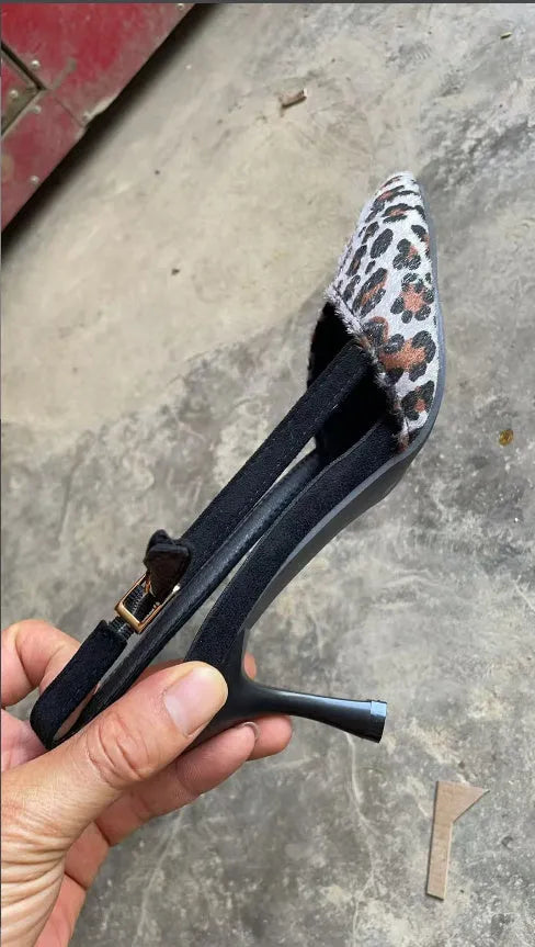Leopard print women's suede sandals with a pointed toe, shown from the side.