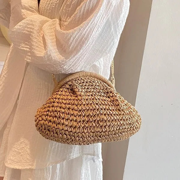 Women's straw beach bag with chain trim in khaki colour, showing shell shape and shoulder strap
