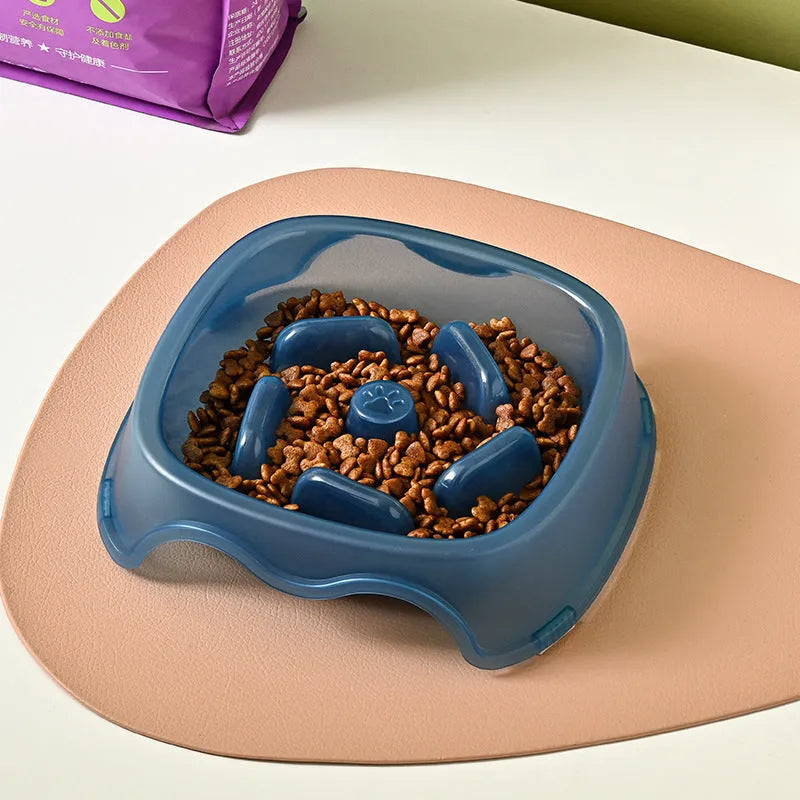 Blue plastic slow feeder dog bowl with anti-choking design on a white background
