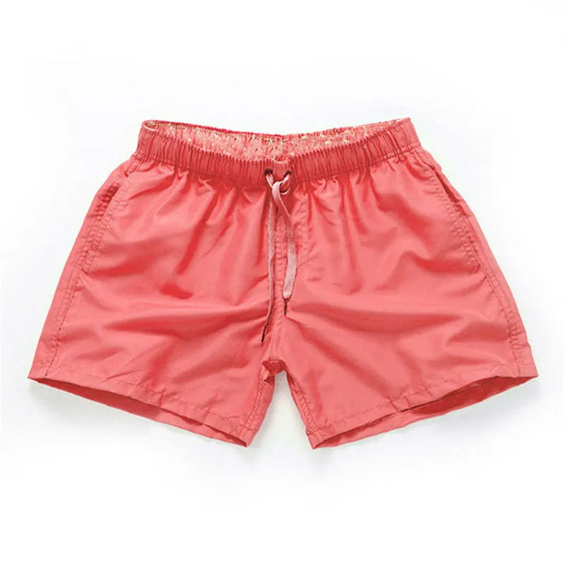 Men's straight-leg beach shorts in polyester fabric on a beach background