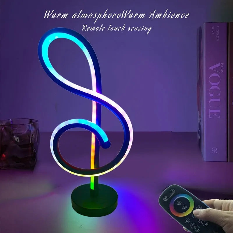 Black musical note shaped Bluetooth light with remote control on a bedside table.