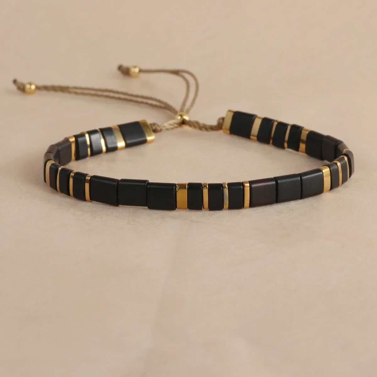Geometric round glass bead bracelet in milky white, black, green, blue, or red.