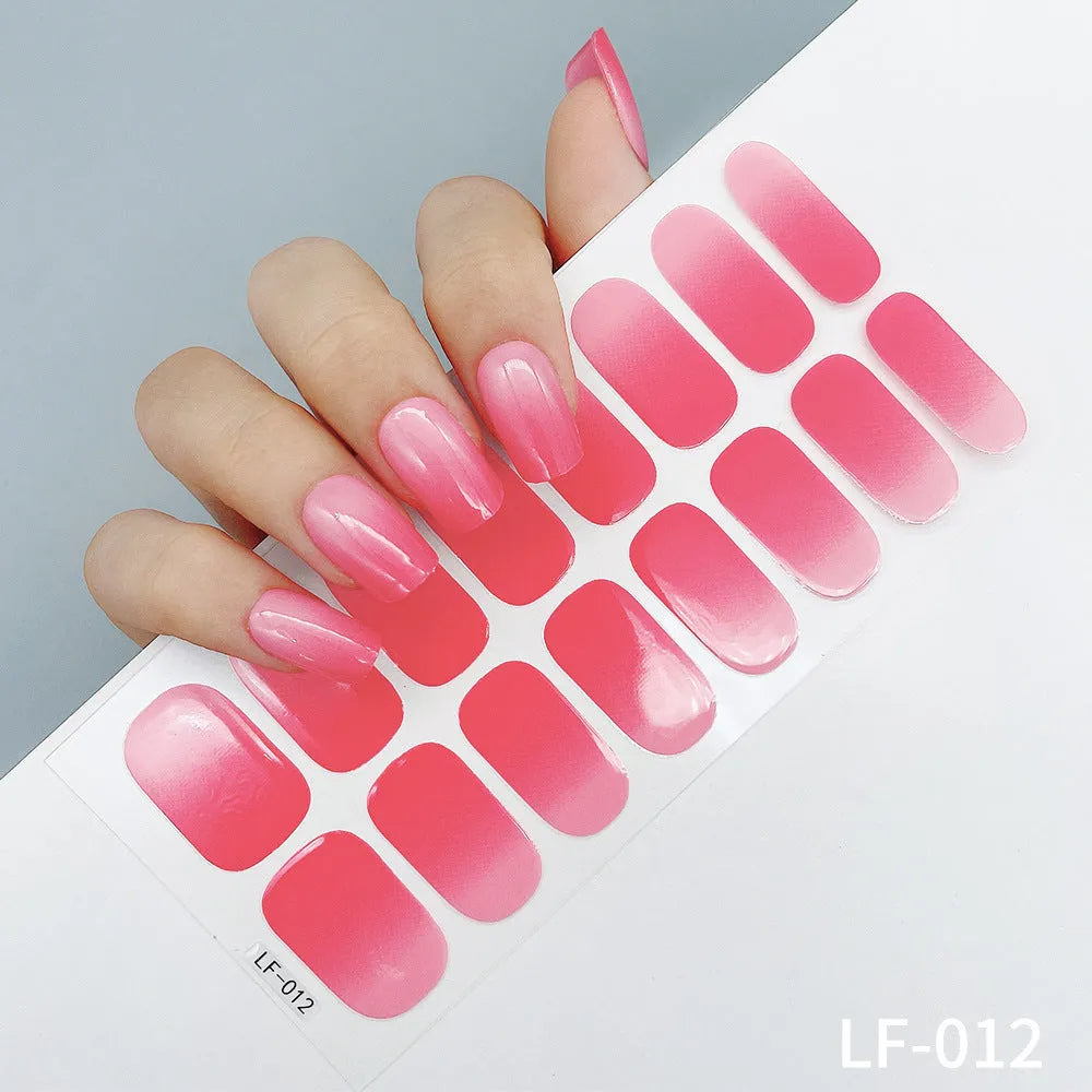 Full sheet of nail art stickers showing sixteen small designs including cross, rose, tulip, and leopard print patterns.