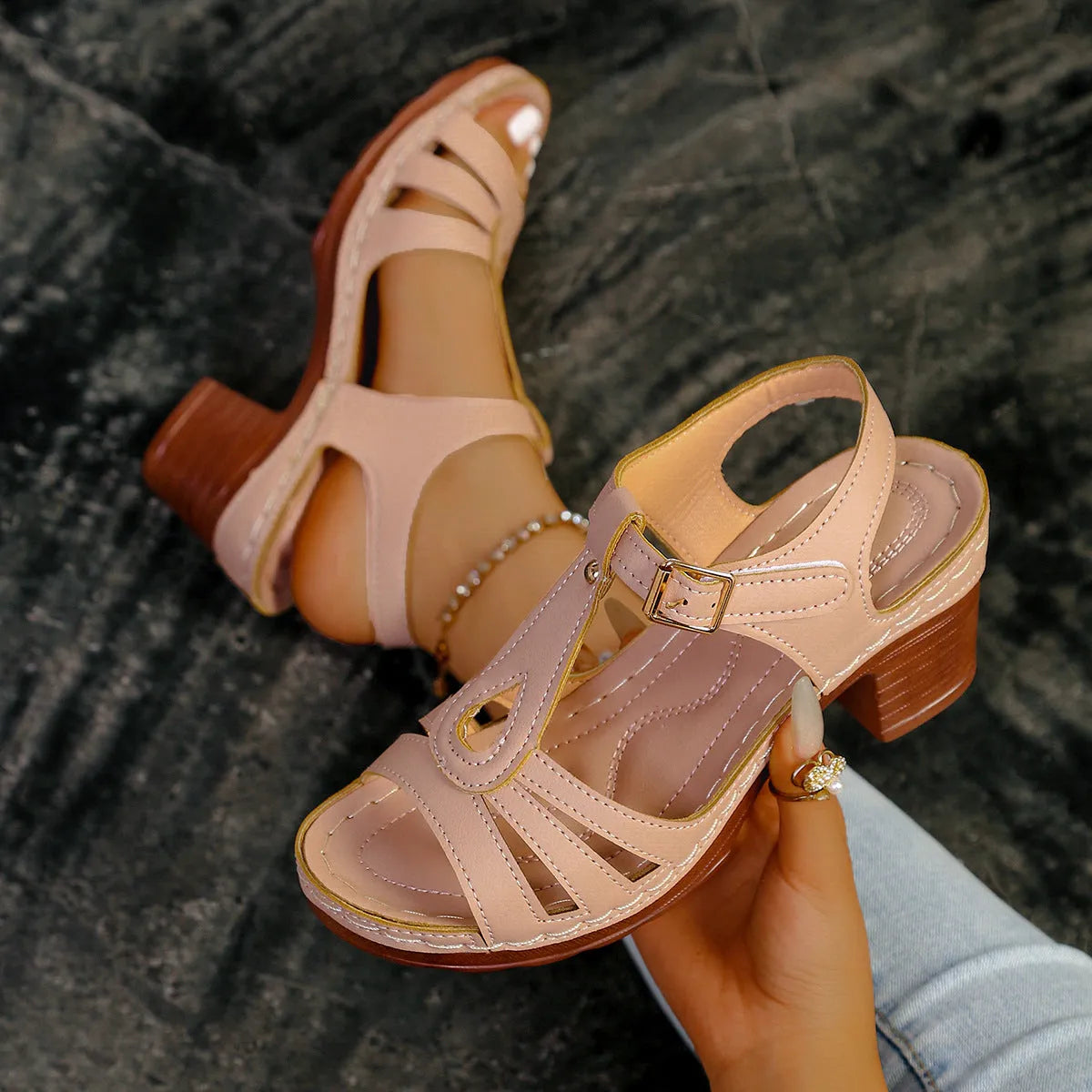 Women's black peep toe wedge sandals showing buckle fastening and fish mouth toe design