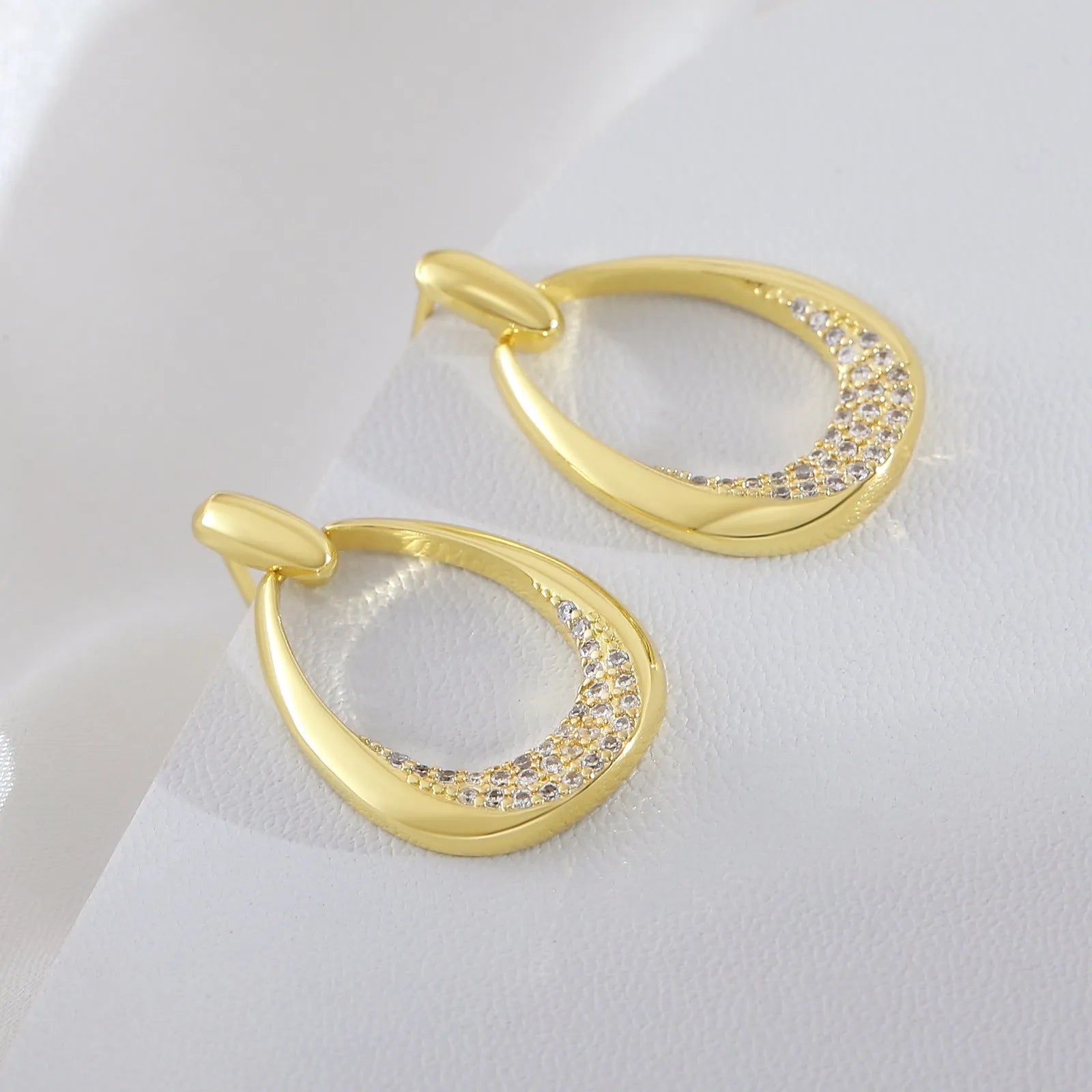 Women's geometric drop earrings with zircon details and yellow gold electroplated finish measuring 2.6 by 1.7 cm