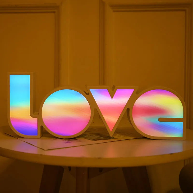LED decorative light with rainbow-coloured LOVE word on plastic shade