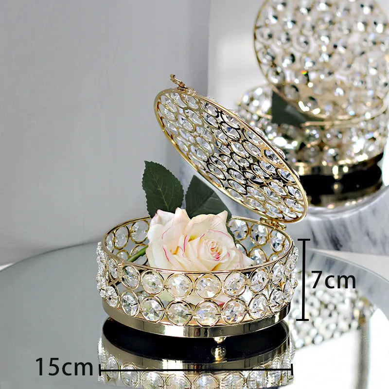 French gold iron frame crystal glass jewellery box with a metal lock closed.
