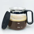 Transparent borosilicate glass pour-over coffee maker with a black silicone cover on a kitchen counter.