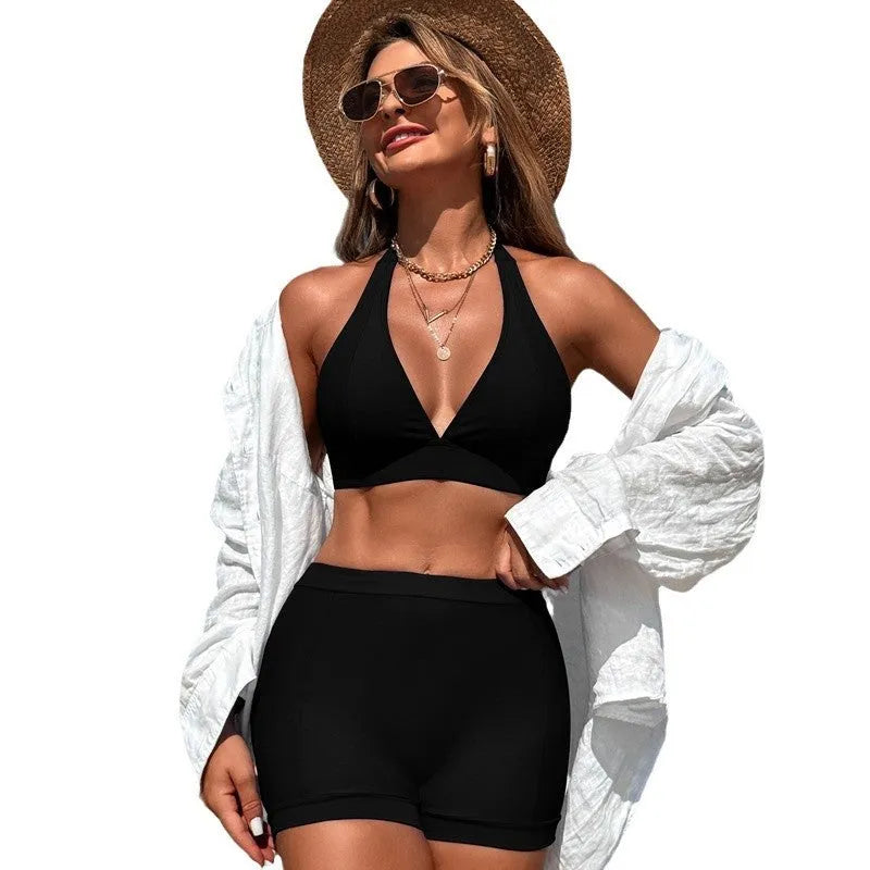 Women's black nylon bikini swimsuit laid flat, showing sleeveless design.