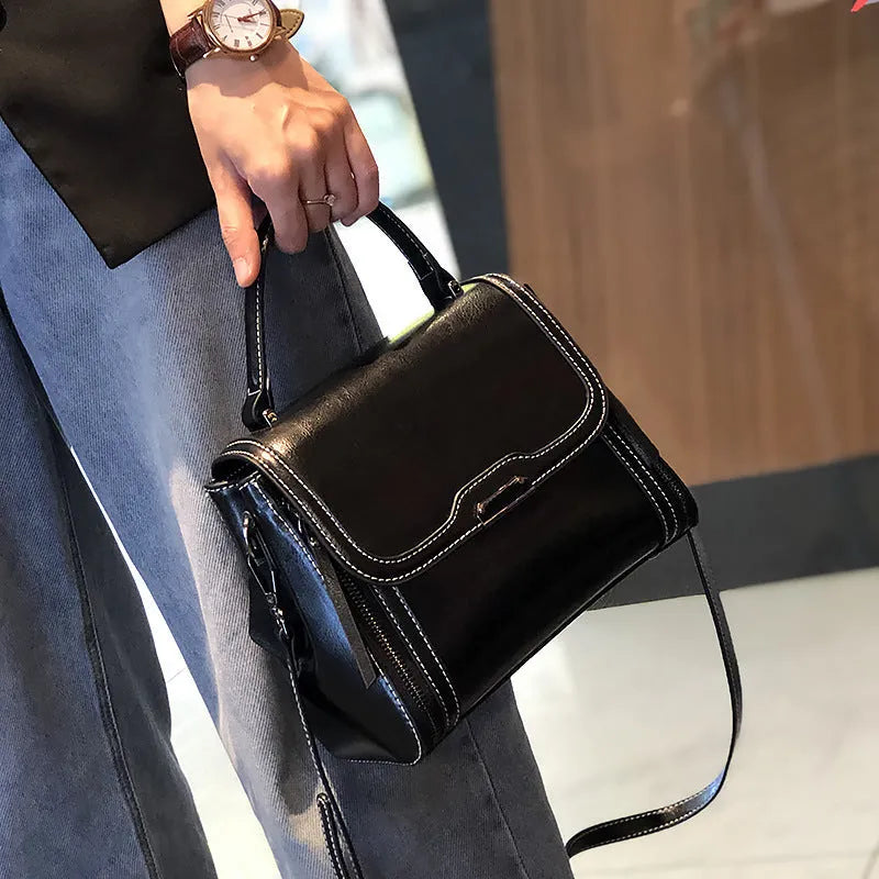 Women's retro style genuine leather messenger bag in horizontal square shape with multiple internal compartments