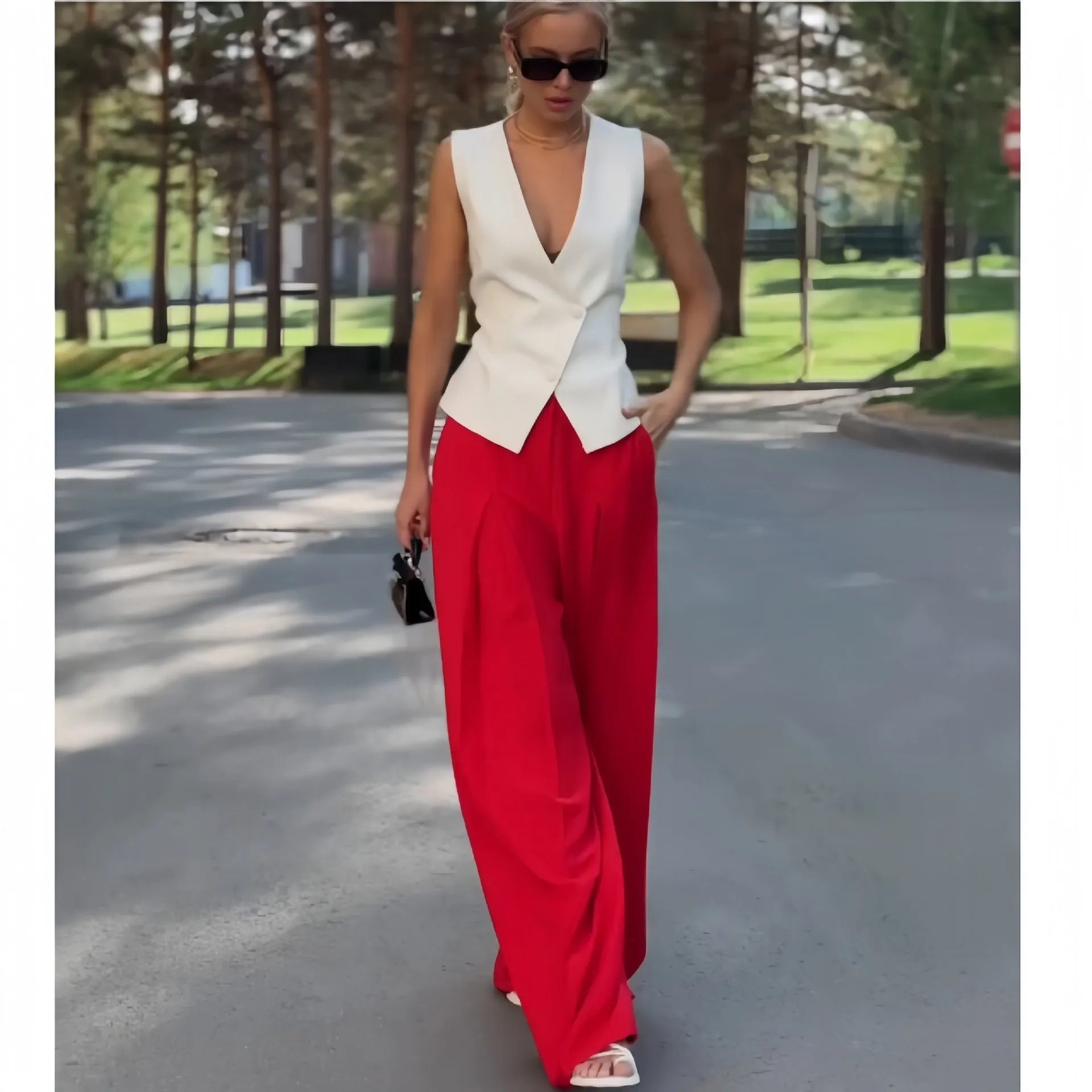 Women's beige two-piece set with deep V-neck sleeveless top and high-waisted wide leg trousers.
