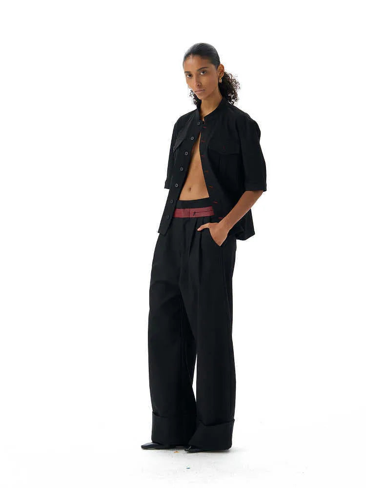 Black handmade loose fit half sleeve hunting shirt with a traditional shirt collar on a hanger.