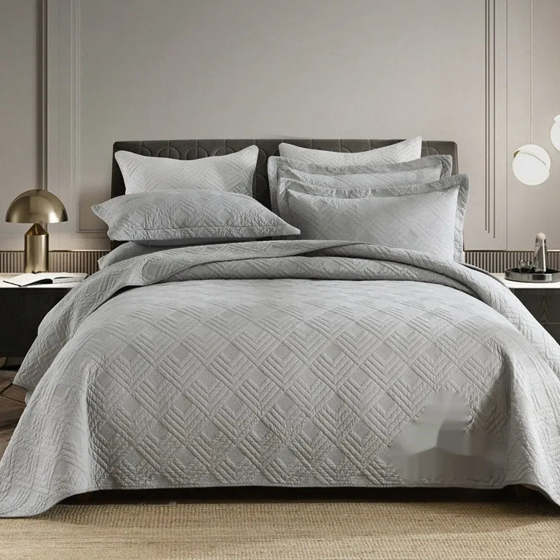 Pure cotton double-sided bed cover three-piece set in a plain colour laid on a bed.