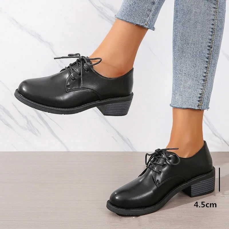 Black women's low-top work shoes with a chunky heel, rounded toe, and soft rubber sole.
