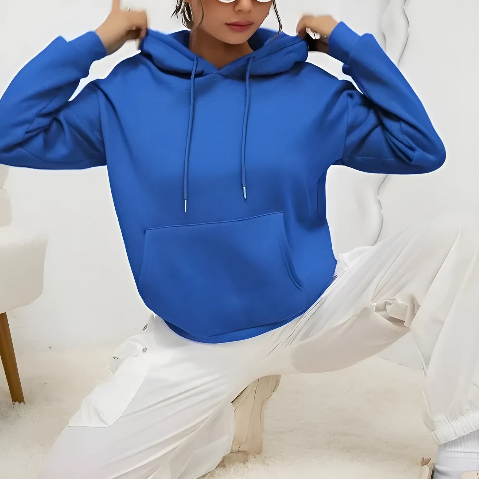 Women's loose drawstring pocket sweatshirt in various colours showing front pockets and adjustable collar