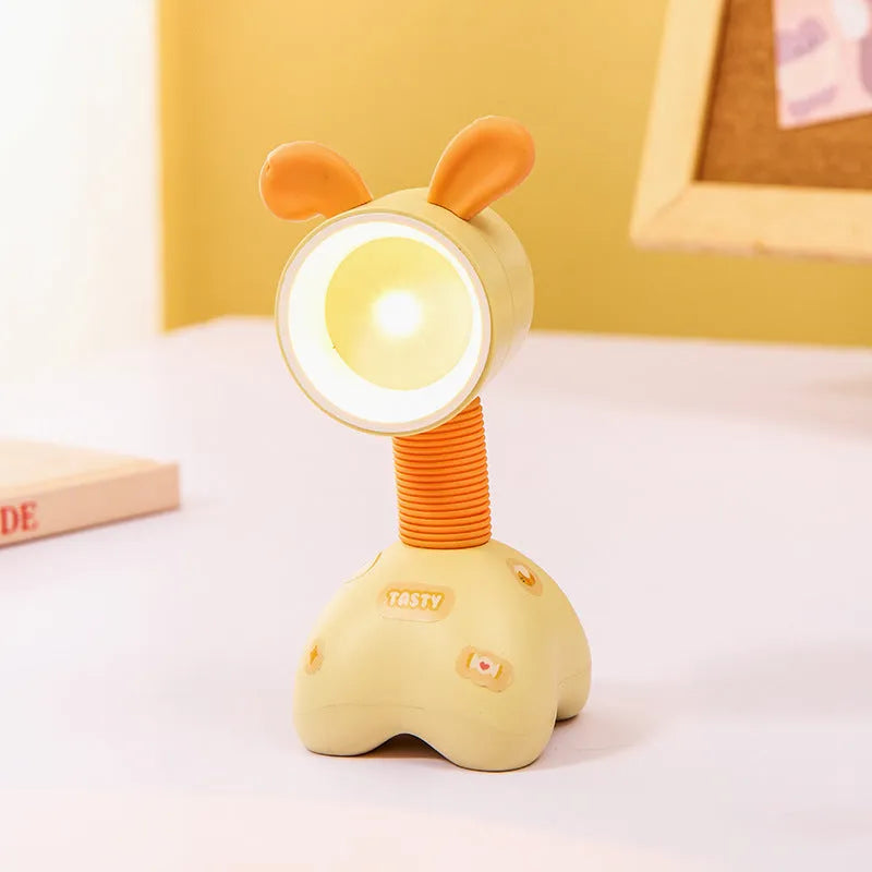 DIY cartoon animal small night lamp with magnetic base in assorted colours on a desk.