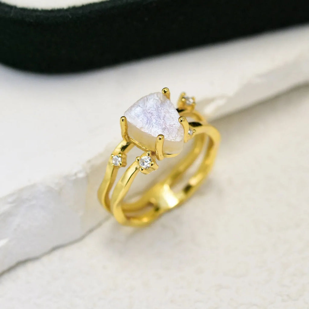 S925 sterling silver ring with irregular triangle shape holding a moonstone, shown in rose gold electroplated finish.