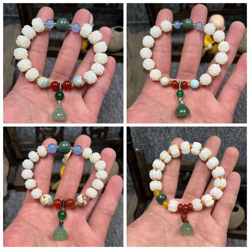 Carved Bodhi root bracelet with white jade, lotus, and pumpkin beads in various sizes.