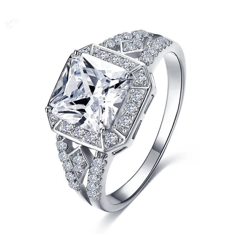 Geometric hollow zircon ring in platinum colour with four-sided design on woman's finger
