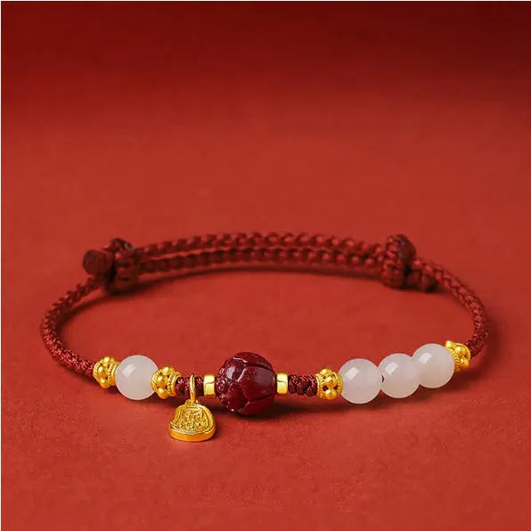 Hetian jade and cinnabar red rope women's bracelet with adjustable sterling silver chain.