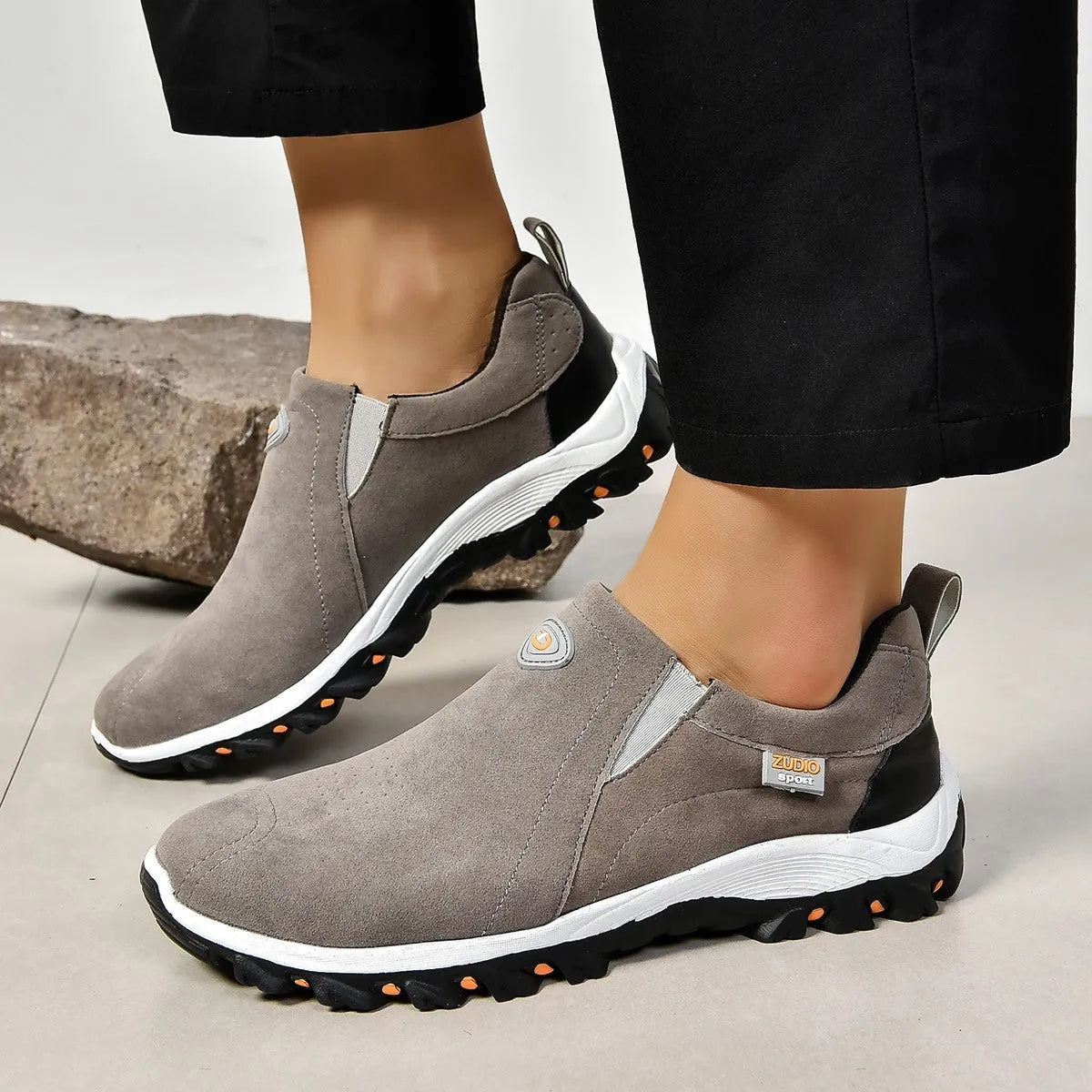Men's black elastic slip-on shoe covers with round toe and rubber sole, showing PU upper material.