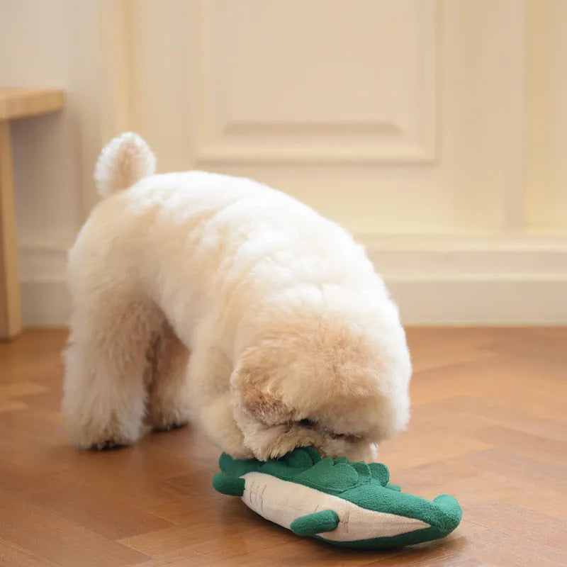 Green soft plush dog toy with embroidered face featuring squeaker and rattle for infant play