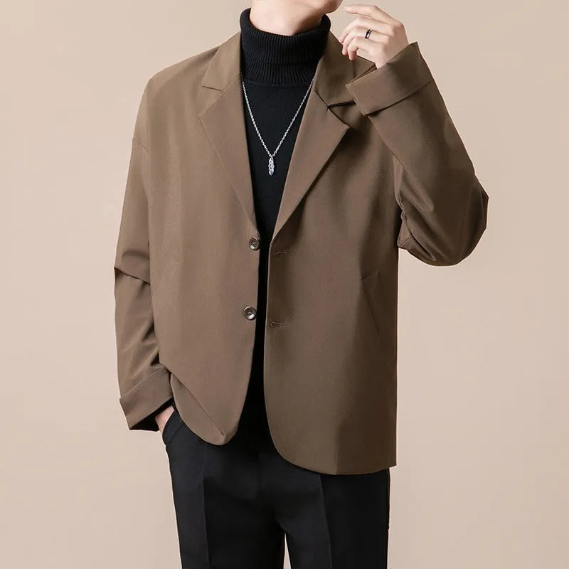 Men's loose fit light business style suit jacket in a polyester blend fabric, shown on a hanger.