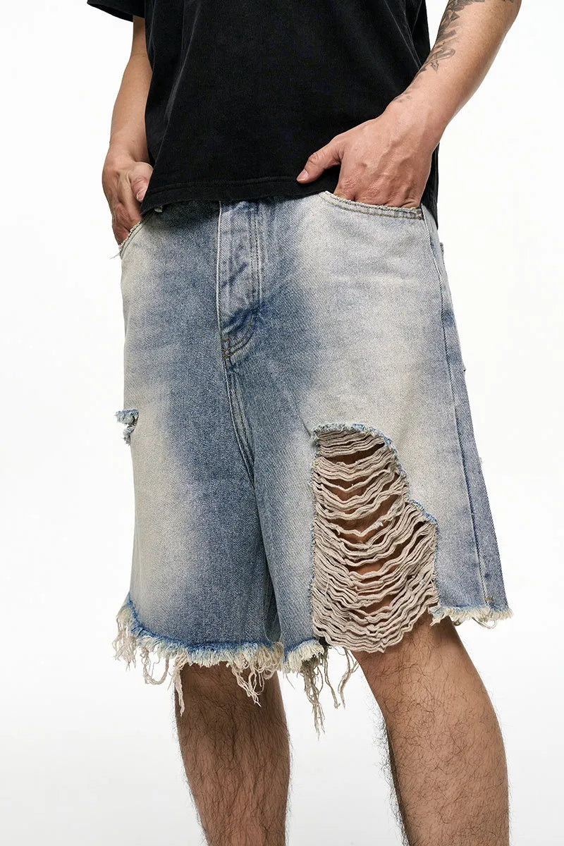 Light blue men's baggy denim shorts with a wide leg and retro washed finish on a mid waist.