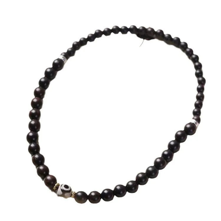 Ebony wood bracelet with 8mm beads showing two circles pattern, unisex design