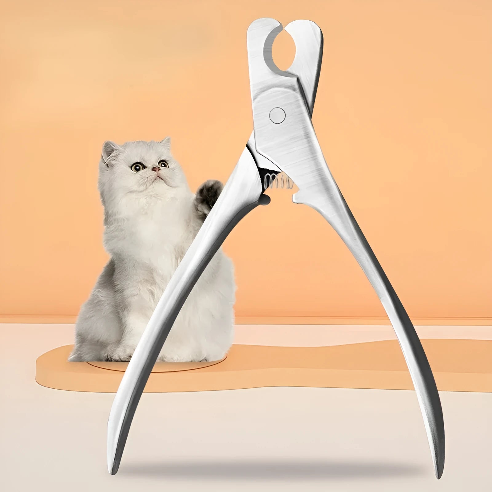 Silver stainless steel pet nail clipper with ergonomic handle and safety guard for dog and cat grooming.