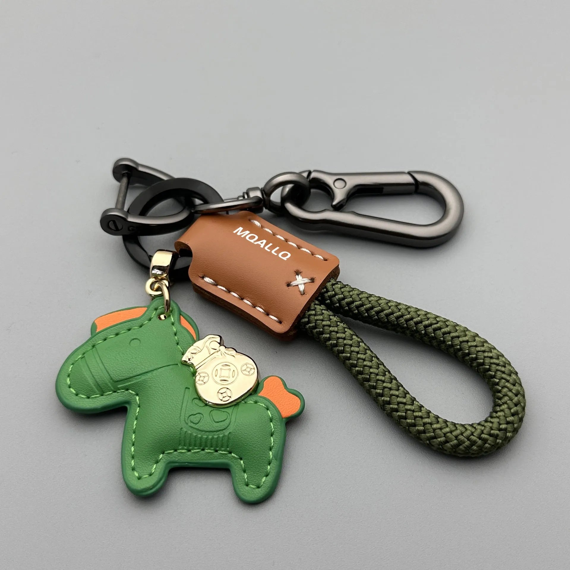 Zinc alloy car keychain pendant with a strap made of brown cowhide and green flannel rope.