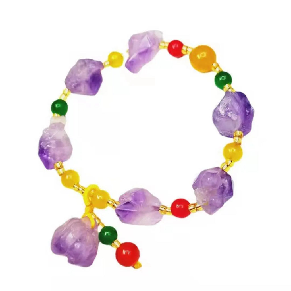 A women's bracelet made of purple natural amethyst beads with a fu character charm.
