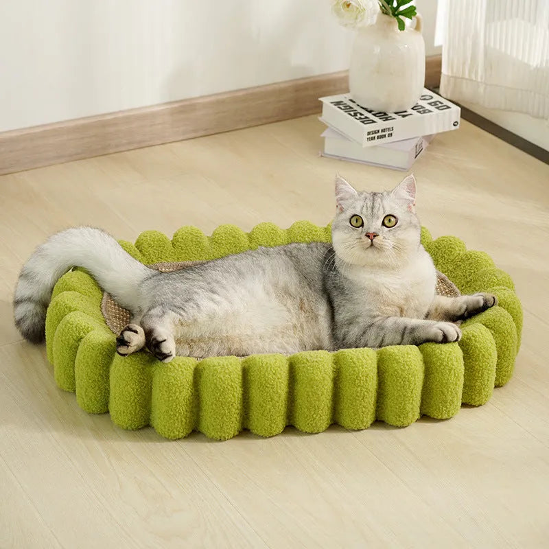 Green oval cat scratcher bed with sisal scratching surface measuring 65x42cm