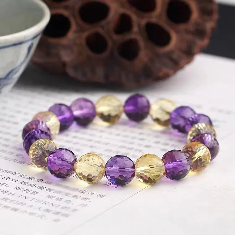 Handmade ametrine bracelet with 128-facet crystal beads in a choice of diameters and symbolic designs.