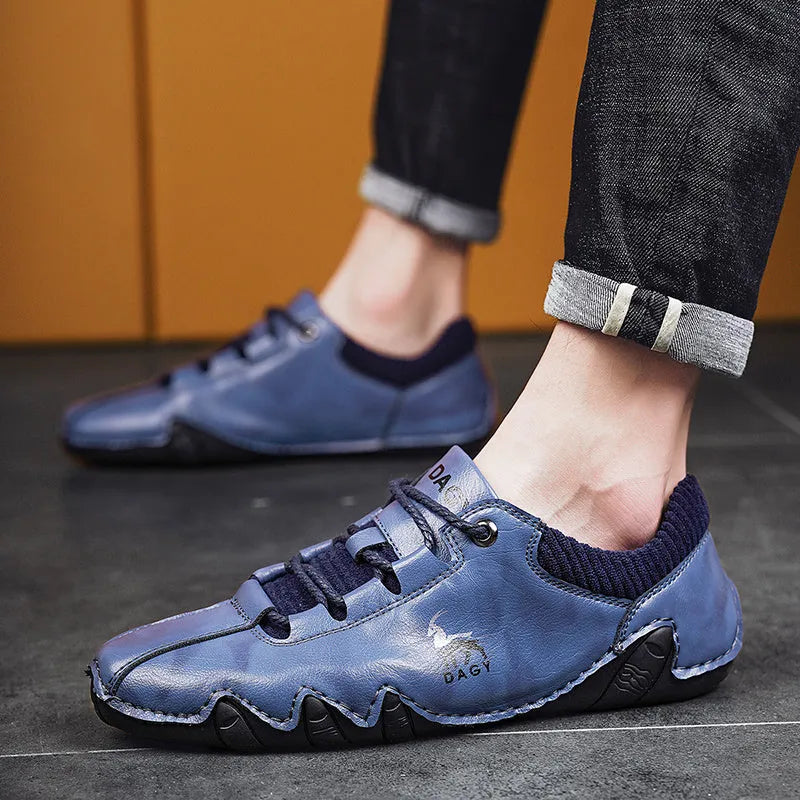 Men's solid colour lace-up casual sneakers with car stitching, blue upper, side view