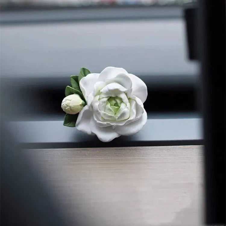 Solid gypsum car air freshener diffuser in air vent with jasmine fragrance oil.