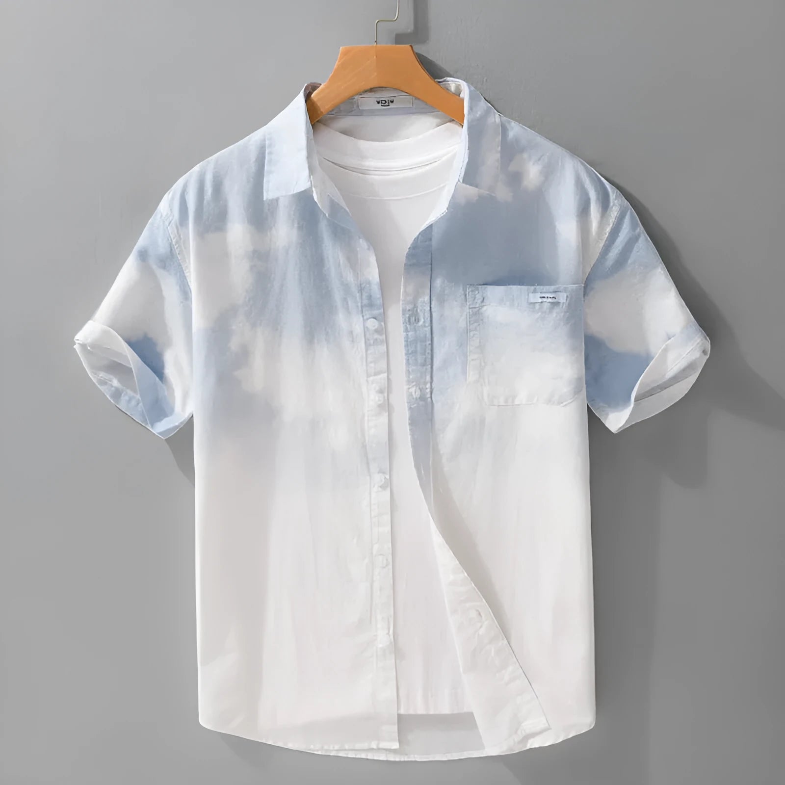 Man wearing a light pink loose-fit short-sleeved cotton shirt, casual summer style