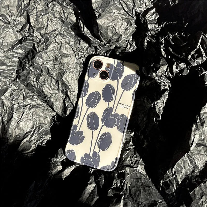 Black silicone iPhone case with a printed tulip floral design on the back.