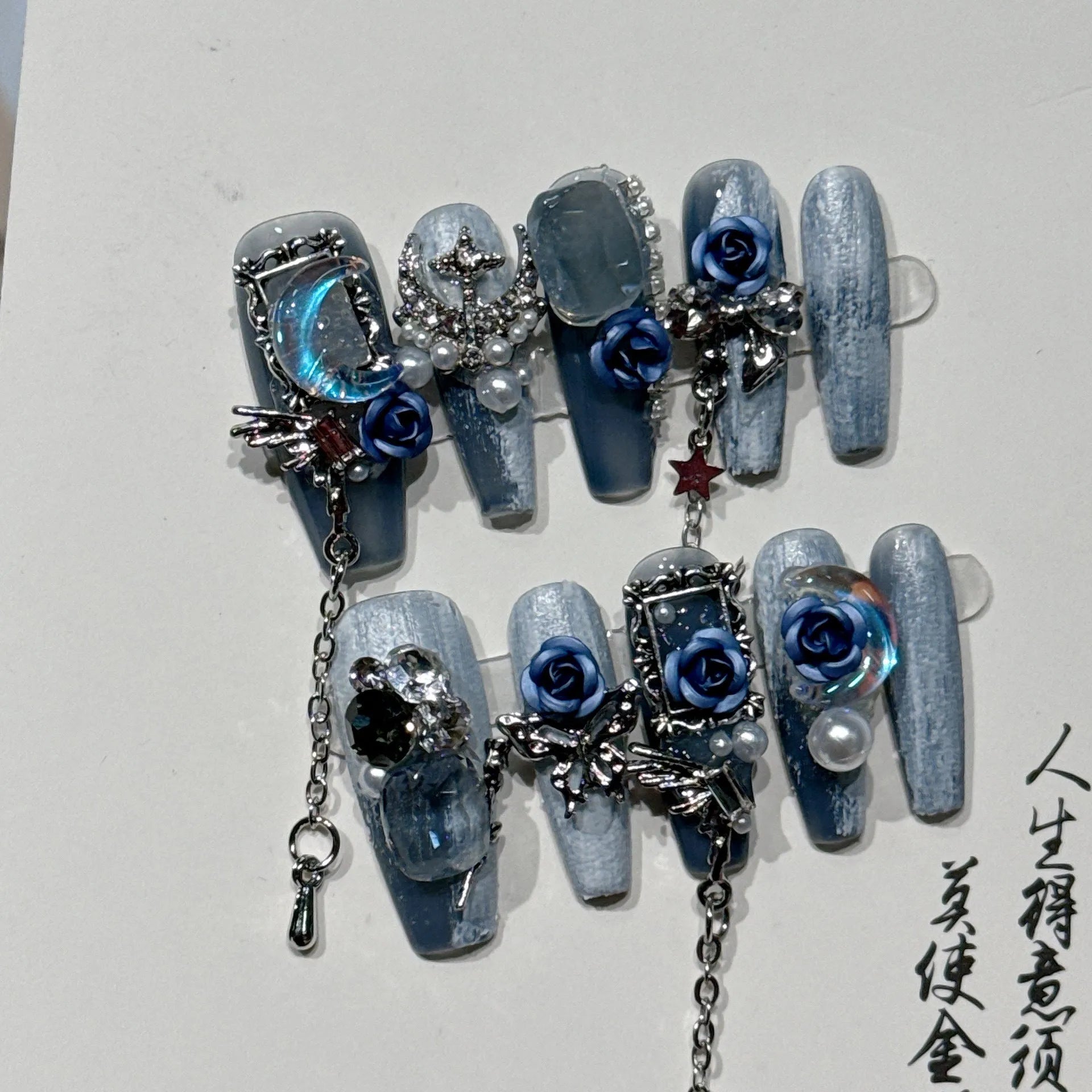 Heavy industry blue false nails with ornate rose and tulip pattern, shown in sizes XS S M L.