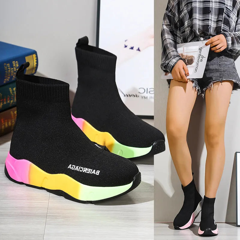 Women's black platform sock boots with cloth upper, rubber sole, round toe, thick heel, and low tube design on a neutral background