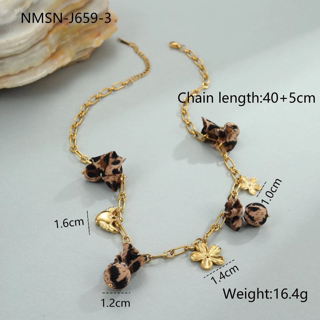 Gold plated stainless steel necklace with geometric leopard, love heart, and flowers pendant on a regular chain.