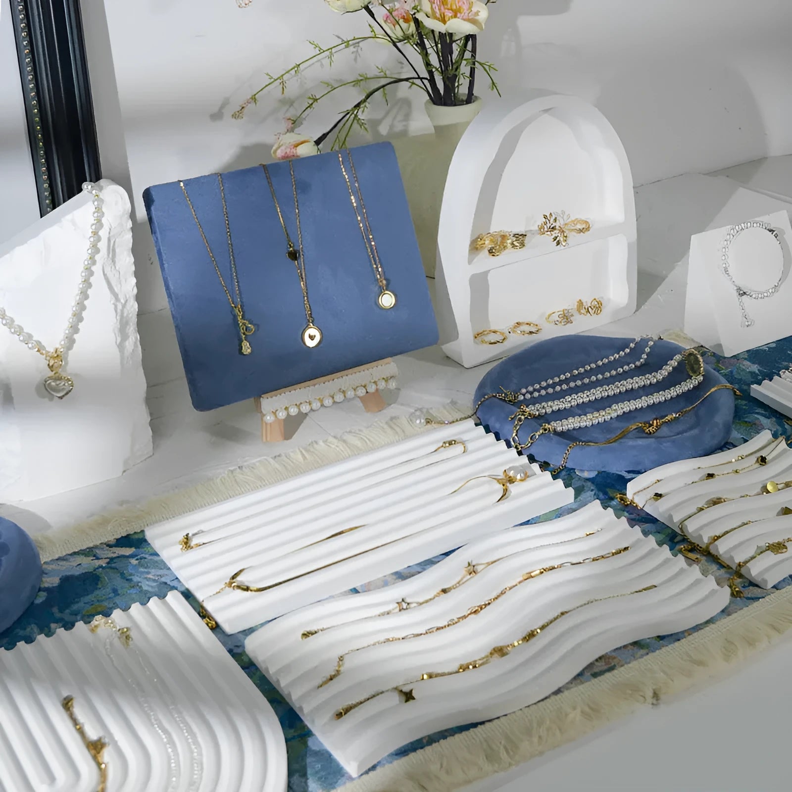 Handmade plaster jewellery display tray with necklaces and bracelets on a countertop