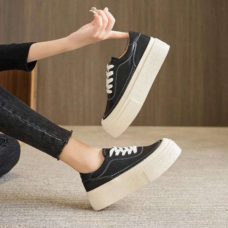 Women's black platform sports board shoes made from embossed cowhide leather with a rubber sole.