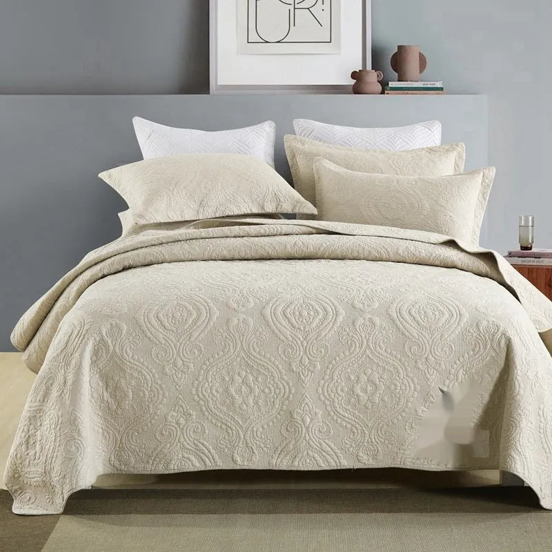 Pure cotton double-sided bed cover three-piece set in a plain colour laid on a bed.