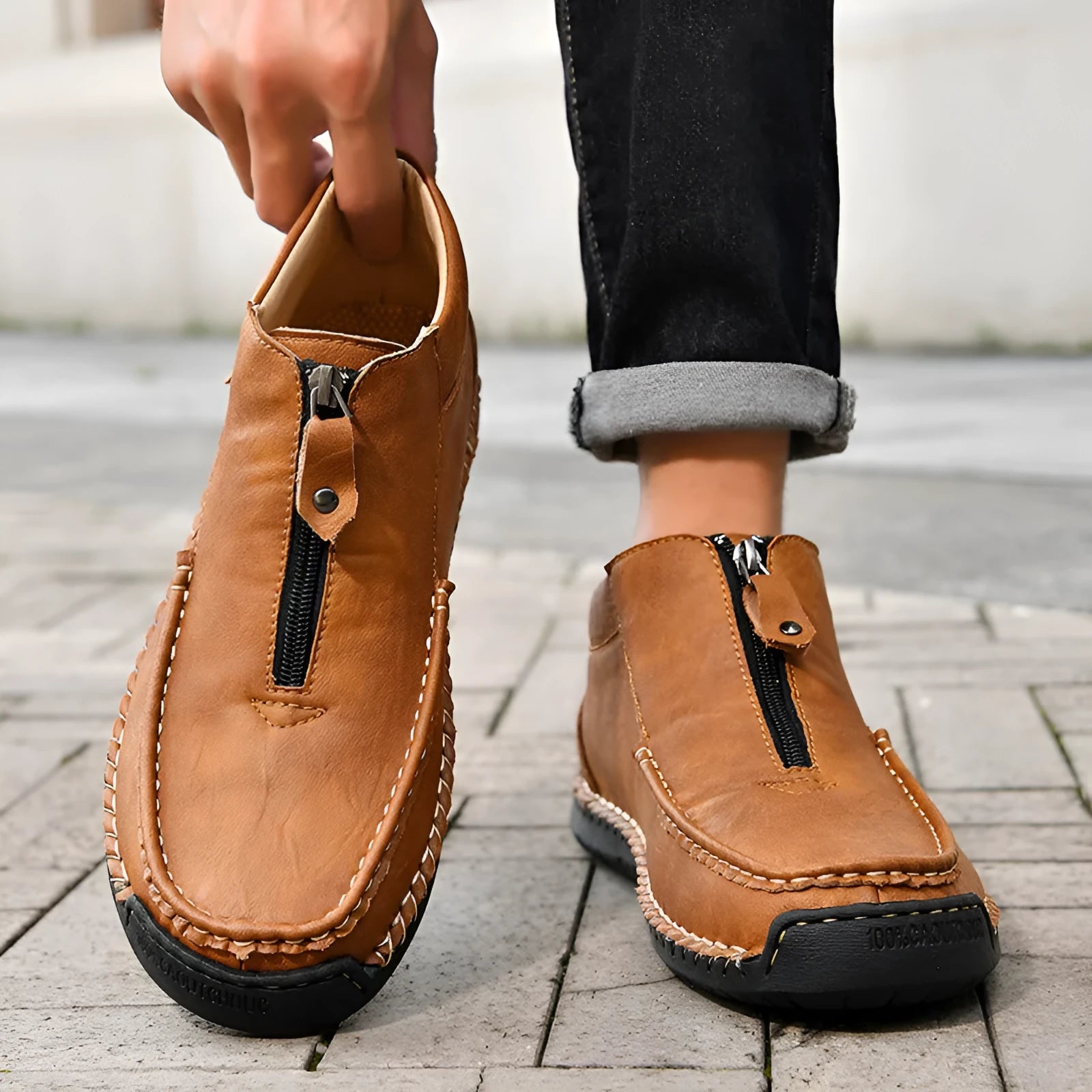 Men's black slip-on loafers with round toe and flat rubber sole on a white background.