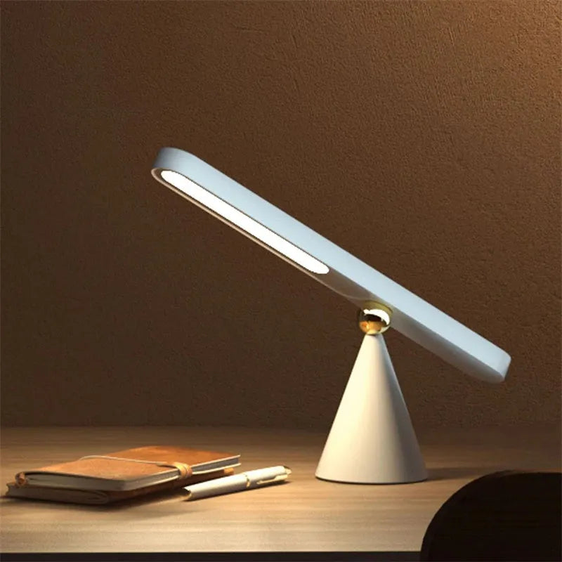 Geometric wireless table lamp with magnetic suction on metal surface showing USB connection